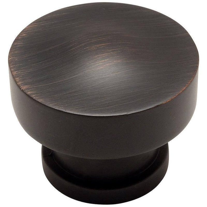 Round drawer knob in oil rubbed bronze finish with slightly convex surface and one and a quarter inch diameter