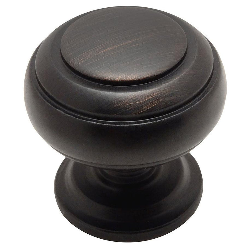 Round cabinet knob in oil rubbed bronze finish with two rings engraving and one and a quarter inch diameter