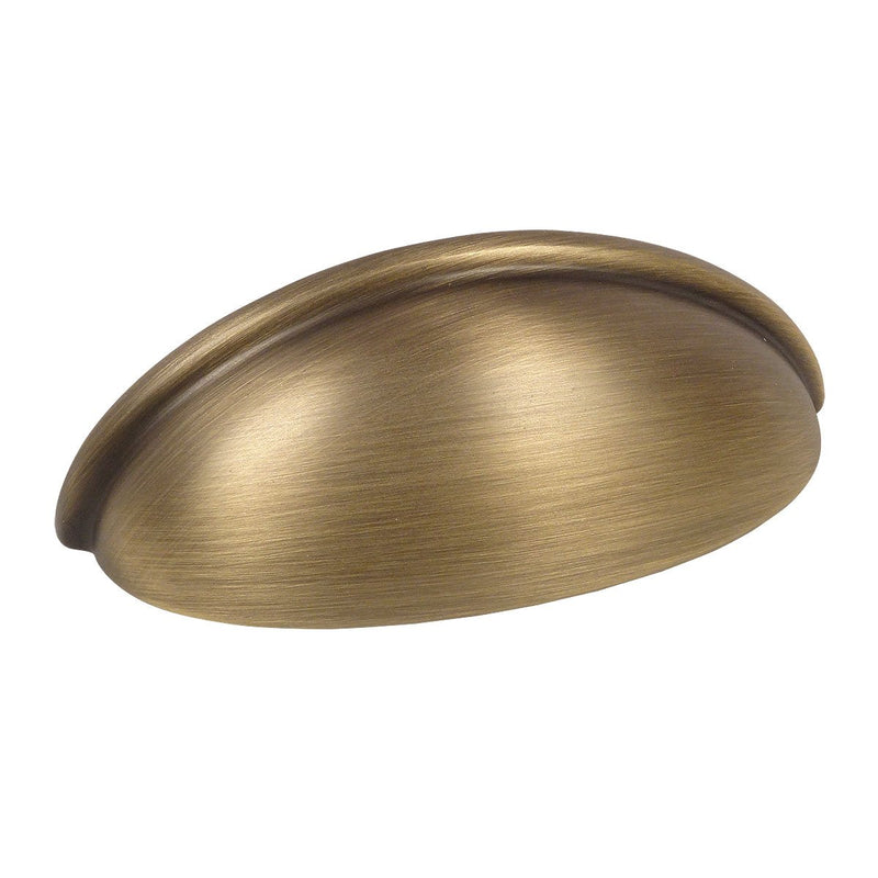 Cabinet cup pull in brushed antique brass finish with three inch hole spacing