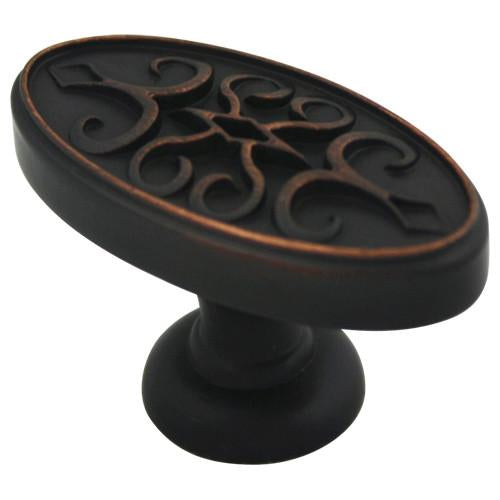 Oval cabinet knob in oil rubbed bronze finish with swirl carving on the face and one and three quarters inch length