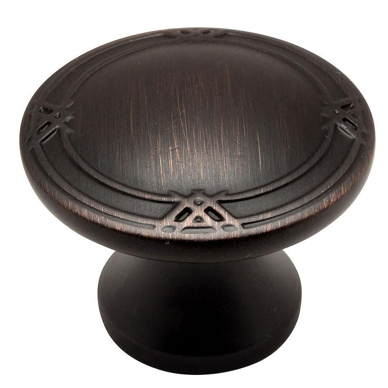 Oil rubbed bronze drawer knob with small crossings carving on the edges and one and five sixteenths inch diameter