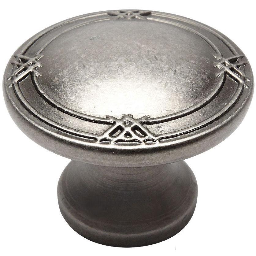 Weathered nickel cabinet knob with one and five sixteenths inch diameter and small crossings carving on the edges