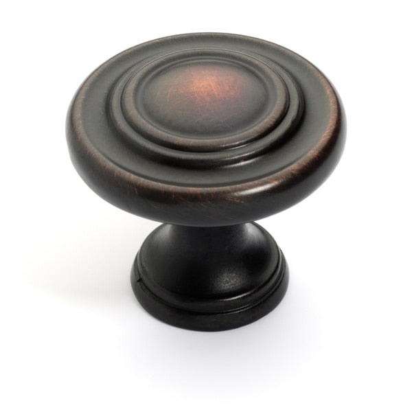 Round oil rubbed bronze drawer knob with rings accent and one and a quarter inch diameter