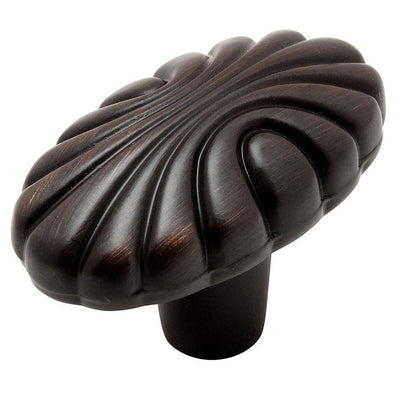 Oval cabinet knob in oil rubbed bronze finish with half circle carvings on the face