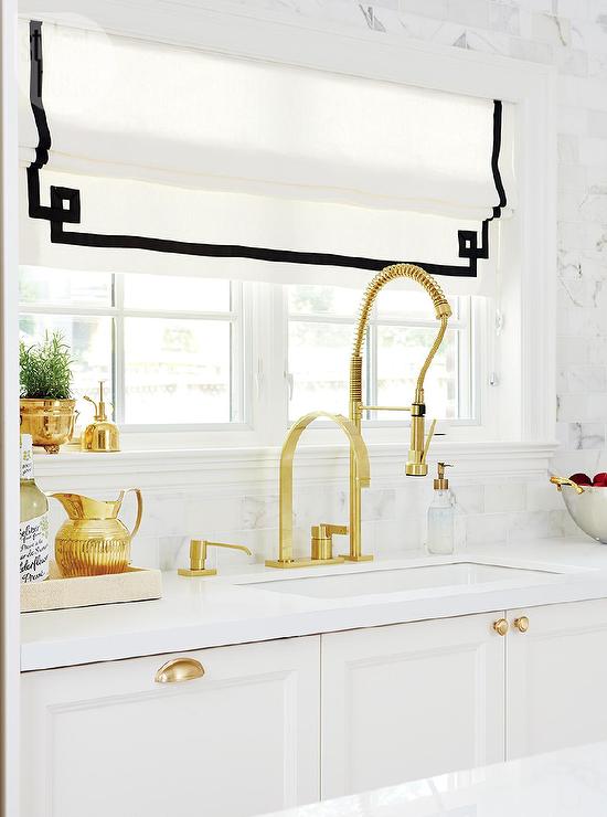 Cosmas 4310BB Brushed Brass Cabinet Cup Pull in kitchen with gold knobs. Brass and gold white kitchen