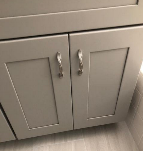 Brushed Nickel twist braided pulls on a light gray cabinet door. Cosmas 9009SN pulls are versatile and a pretty addition to drawers, cabinets and furniture. 