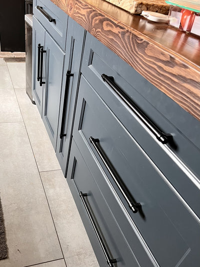 Large flat black appliance pull in kitchens. Oversized blue cabient drawers with black extra long pulls. The heavy duty black pulls featured are Cosmas 161-319FB Flat Black Cabinet Hardware Euro Style Bar Pulls