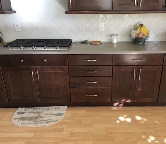 Cosmas 2363-4SN Arch pull in kitchen with wood cabinets