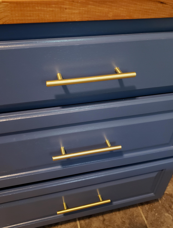 Cosmas 305-128BB Brushed Brass Euro Style Bar Pull on blue cabinets