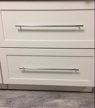 Cosmas 404-673SN appliance Bar Pull on white shaker cabinets