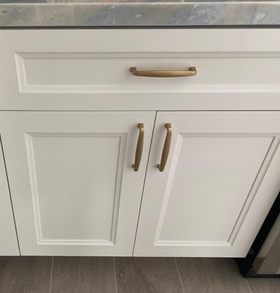 Gold Champagne Cabinet Pulls on white cabinets and dark hardwood floors