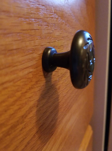 Cosmas 464ORB Oil Rubbed Bronze Cabinet Knob side view installed on dresser