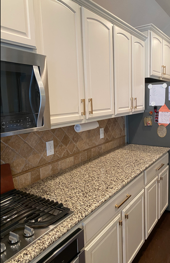 Cosmas 702-160GC on pulls on white cabinets with stainless steel appliances