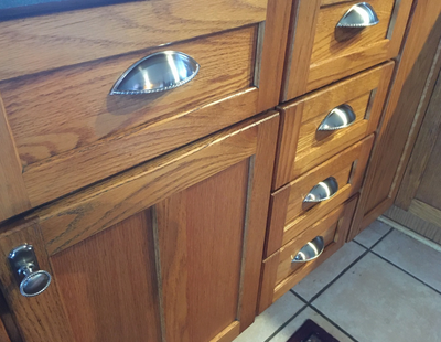 Cosmas 9237SN Satin Nickel Cabinet Cup Pulls on oak kitchen cabinets. 