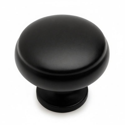 Round flat black cabinet knob with subtle beveled lip design and one and three sixteenths inch diameter
