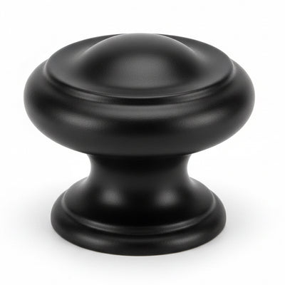 Round cabinet knob in flat black finish with slightly raised ring and one and three sixteenths diameter