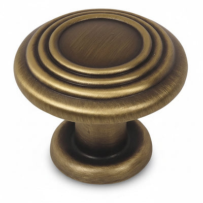 Brushed antique brass drawer knob with three raised rings on the face