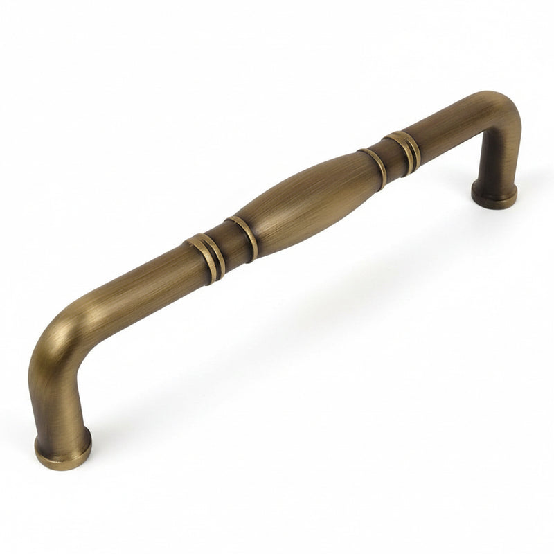 Brushed antique brass cabinet pull with a bulge at the centre of handle and rings aside