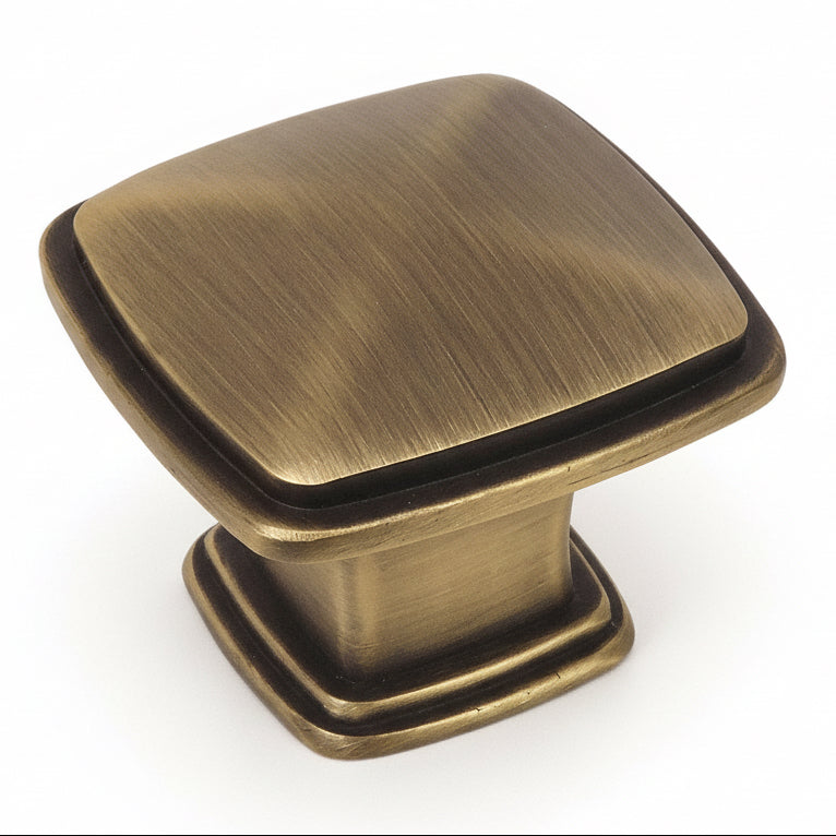 Subtle pyramid drawer knob in brushed antique brass finish with one and a quarter inch length
