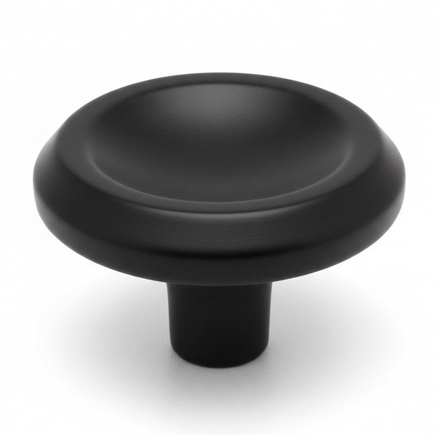 Thicker edges cabinet knob in flat black finish with concave centre and one and an eighth inch diameter
