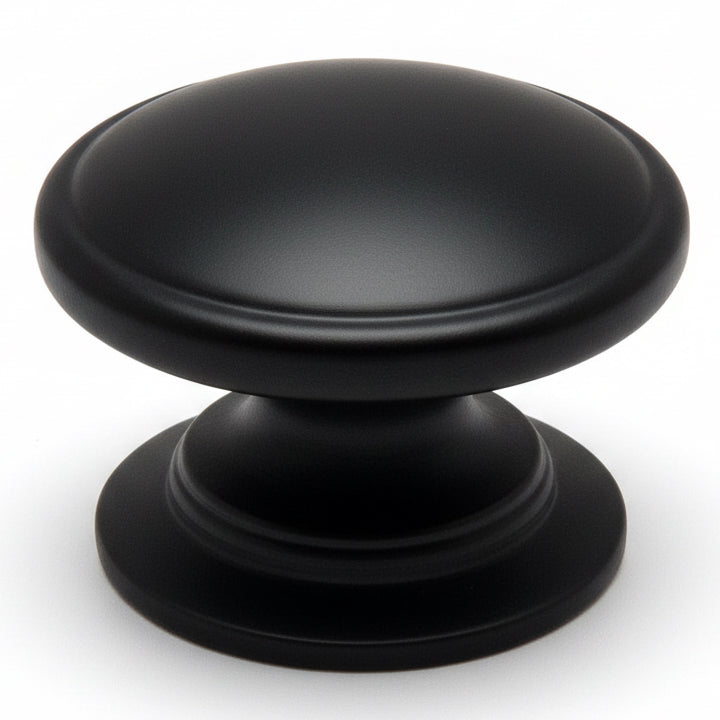 Round cabinet drawer knob in flat black finish with slightly raised centre