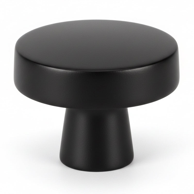 Contemporary round cabinet knob in flat black finish with one and a quarter inch diameter