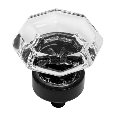 A flat black cabinet knob with a clear glass octagonal face.