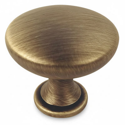 Brushed antique brass round cabinet drawer knob with one and three sixteenths inch diameter