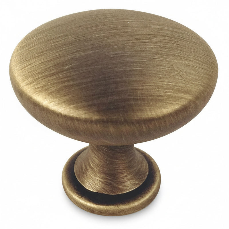 Brushed antique brass round cabinet drawer knob with one and three sixteenths inch diameter