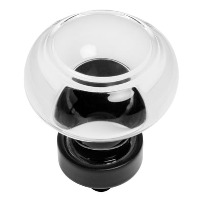 A flat black cabinet knob with clear glass top.