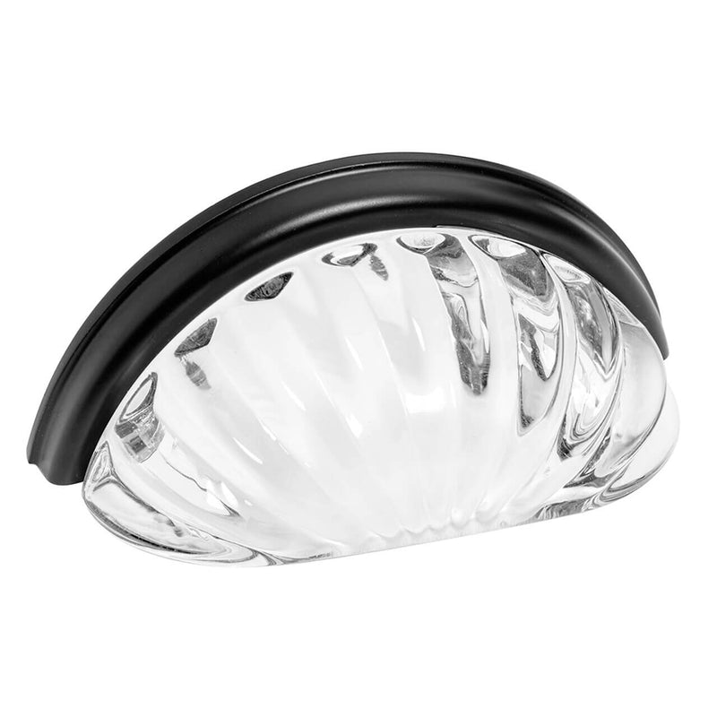 A flat black cabinet cup pull with clear glass inset.