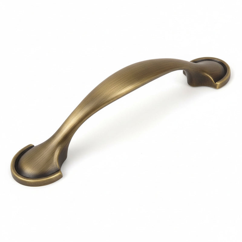 Brushed antique brass drawer pull with three inch hole spacing and shovel shaped ends