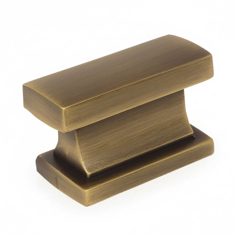 Rectangular contemporary cabinet knob in brushed antique brass finish with one and seven sixteenths inch width