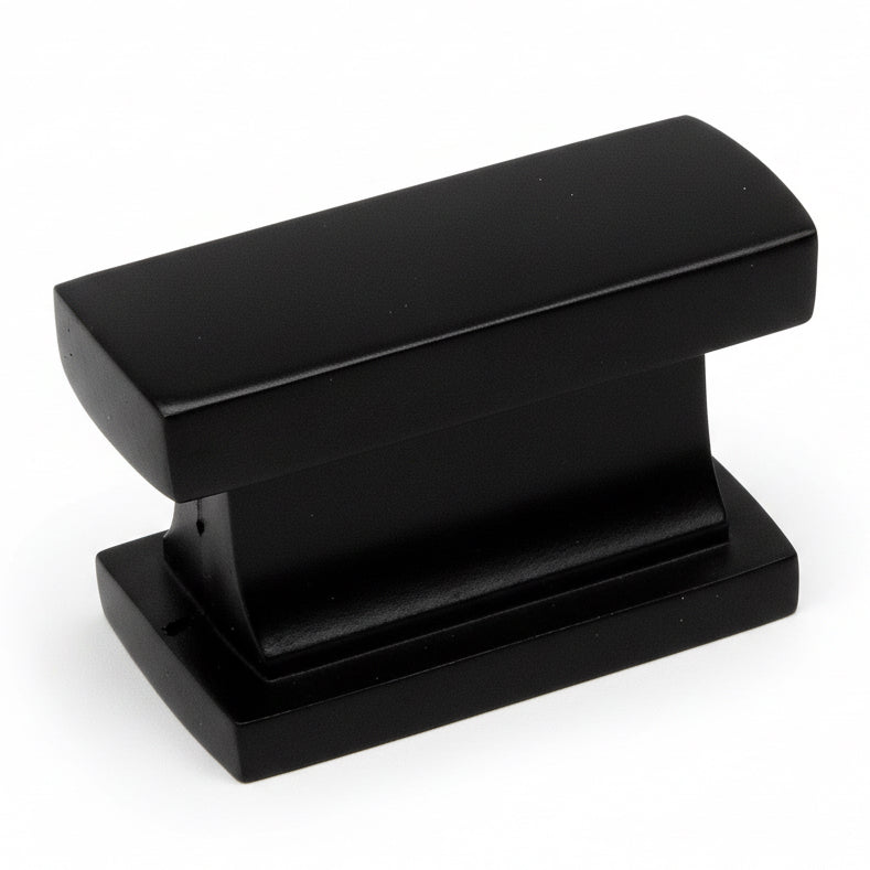 Rectangular drawer knob in flat black finish with one and seven sixteenths inch width