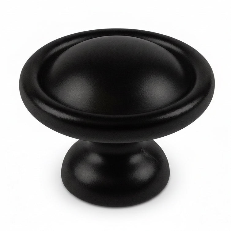 Round cabinet knob in flat black finish with thicker subtle edges