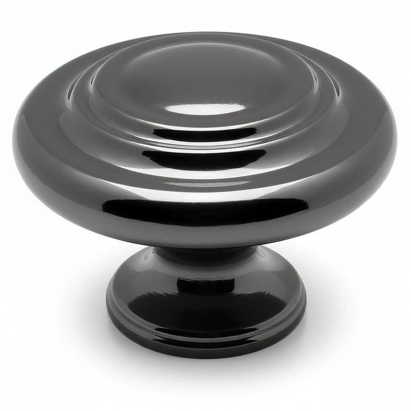 Round cabinet knob in black nickel finish with two raised rings on the centre and thicker subtle edges