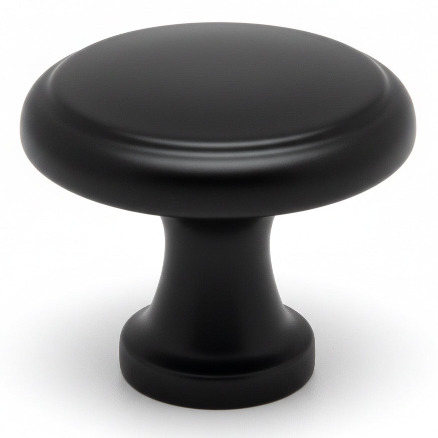Round cabinet knob in flat black finish with slightly raised centre design