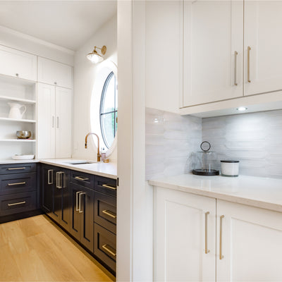 Diversa square edge nickel pulls on white and blue cabinets