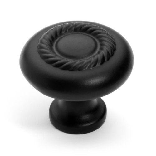 Dove black knob with rope design on the face and circle accent at the center