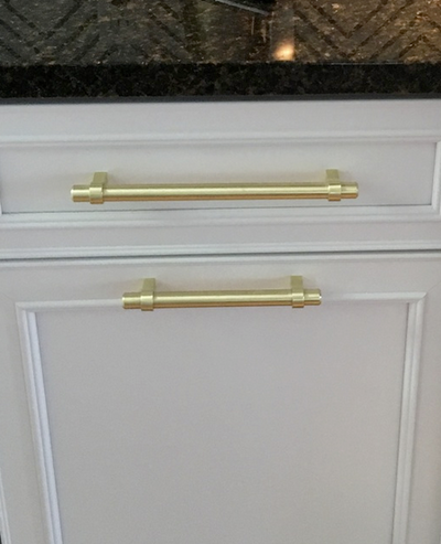 Cosmas 161-4BB Brushed Brass Euro Style Bar Pull on white cabinets with the 161-160BB matching