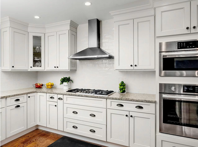 White kitchen with cup pulls and round black nickel knob. Knob is Cosmas 4950BN Black Nickel Cabinet Knob