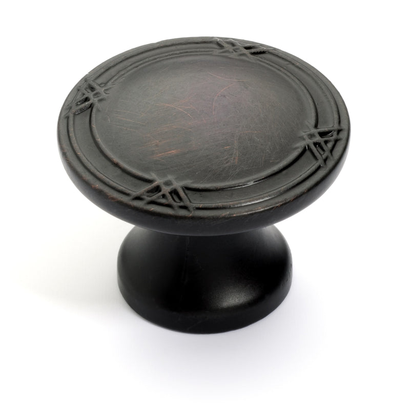 Round coin shaped cabinet knob with ribbons pattern on the face