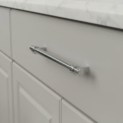 Polished chrome  euro style bar pull on a gray drawer in a kitchen