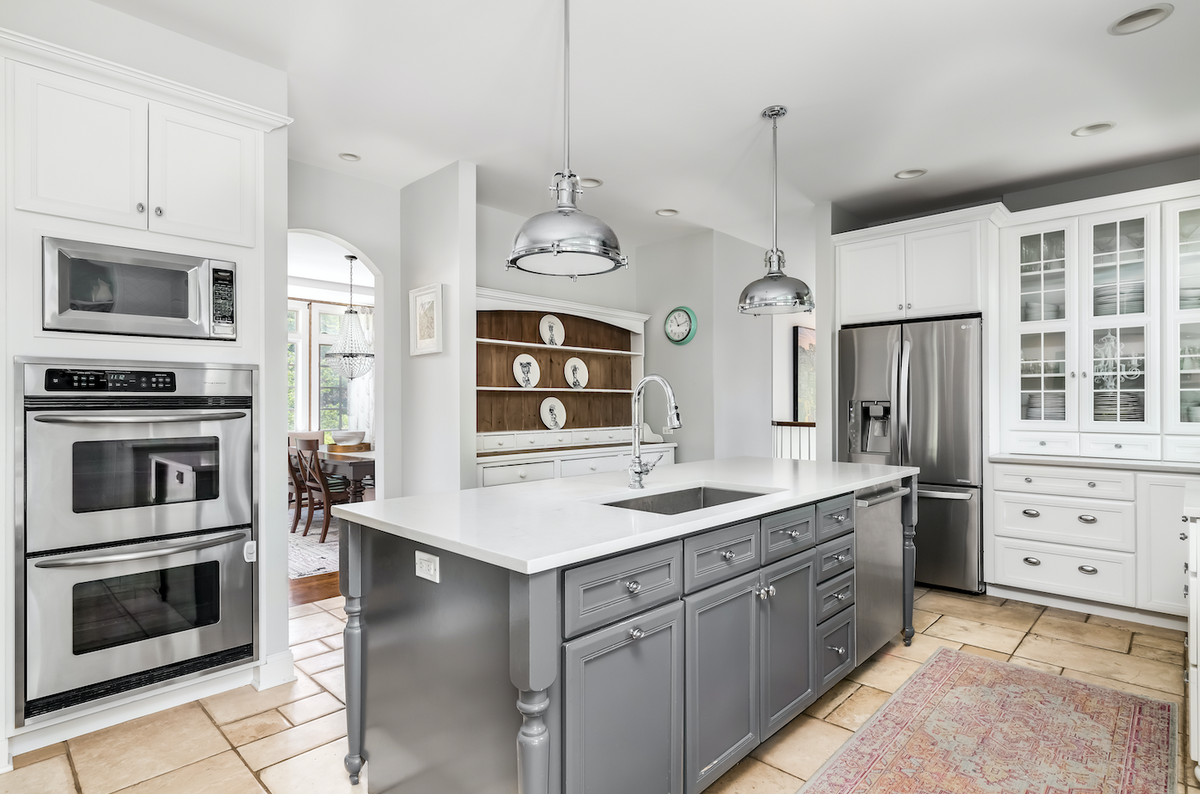 Glass knobs in kitchen on gray cabinets. 